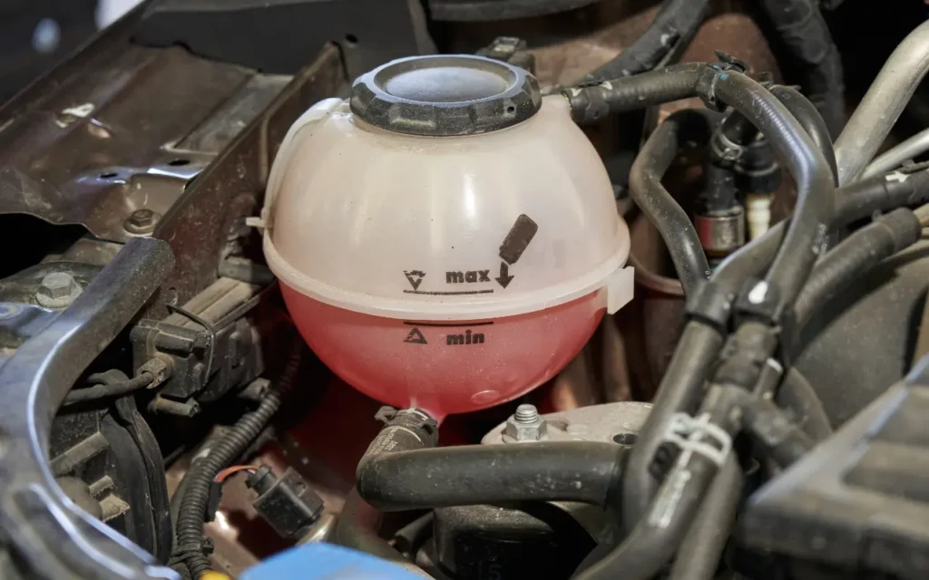 Expansion tank with a pink coolant color.